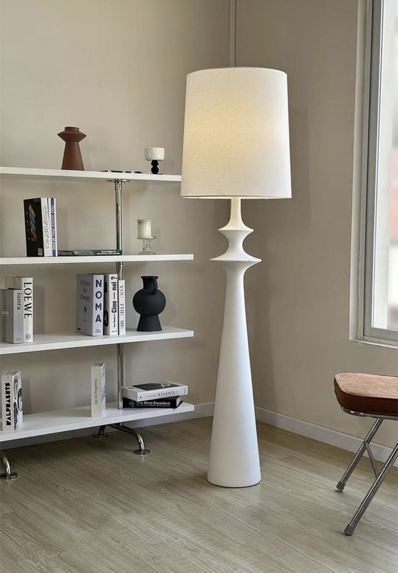 White floor lamp on a solid pedestal base