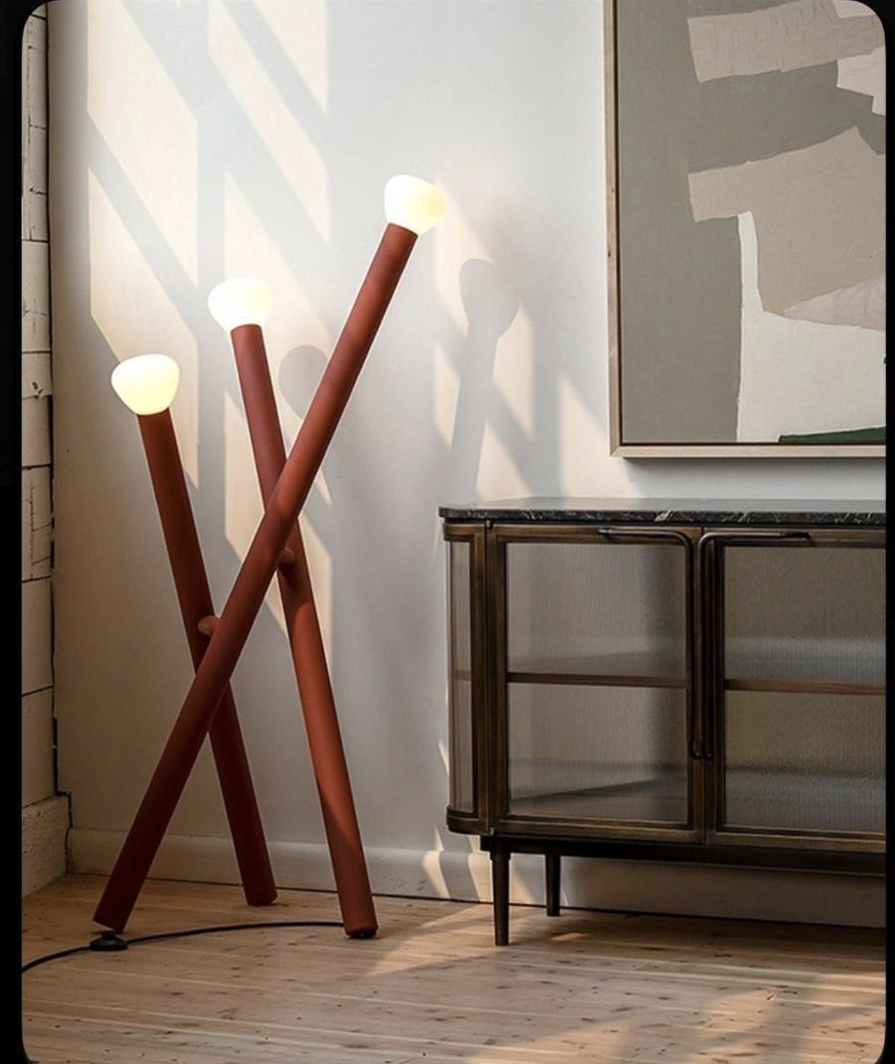Floor lamp with a crossed wooden X-shaped base